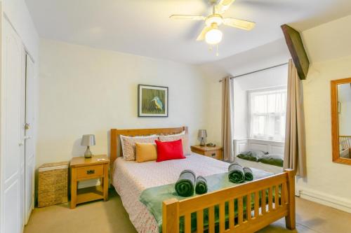 a bedroom with a bed and a ceiling fan at Drum Cottage in Appledore