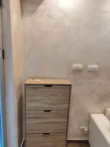 a wooden dresser in a bathroom with a sink at Apartment Majestic in Budva