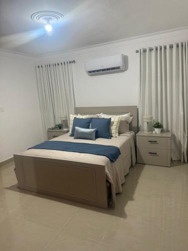 a bedroom with a large bed with blue pillows at Residencial Pancho 6 in La Viva