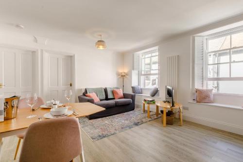 a living room with a couch and a table at Mor Apartment in Looe