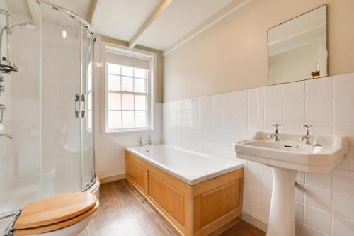 a bathroom with a sink and a shower and a toilet at Storm Cottage in Robin Hood's Bay