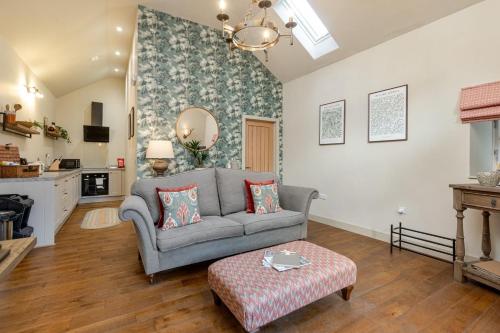 a living room with a couch and a table at Swallows Nest - Barnard Castle in Wycliffe