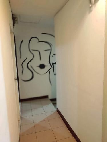 a hallway with a wall with a drawing on it at 雅斤-淡水 in Lun-ting