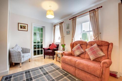 a living room with a couch and a chair at The Shippon in Askrigg in Askrigg