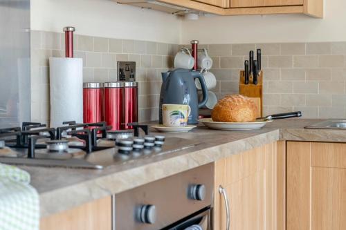 a kitchen counter top with a stove top oven at Little Hendre Barn in Wonastow