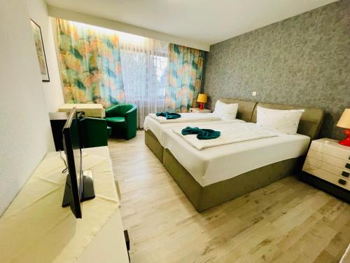 a hotel room with a bed and a couch at Pension De Lux Rain in Rain