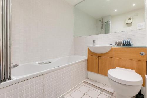 a bathroom with a tub and a toilet and a sink at Headland View in Botallack