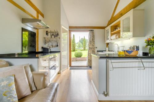 a kitchen with a couch and a counter top at Little Gable in Berrington