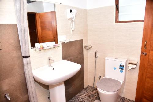 a small bathroom with a sink and a toilet at Kandy Twin Villa in Kandy