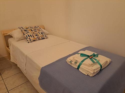two beds with towels sitting on a table in a room at Holidays at the Dock - Fiumicino Airport in Fiumicino