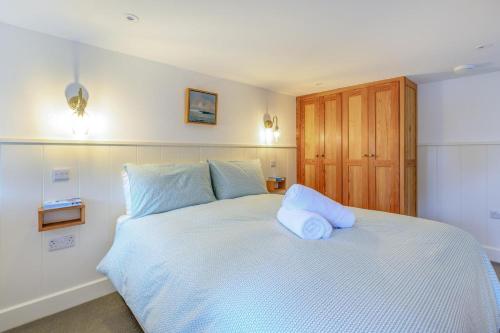 a white bed with two pillows on top of it at Rolling Hills in Woolacombe