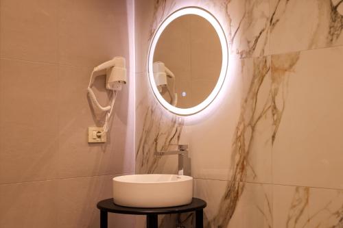 a bathroom with a sink and a mirror at Giselle Escape in Tirana