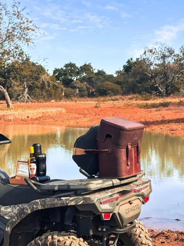 a motorbike with a saddle on the back of a river at Mologa River Lodge in Rust de Winter