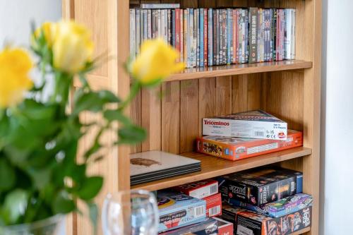 a book shelf with dvds and d movies at Llety-Cariad in Trecastle