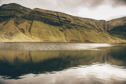 a mountain reflecting in a body of water at Llety-Cariad in Trecastle