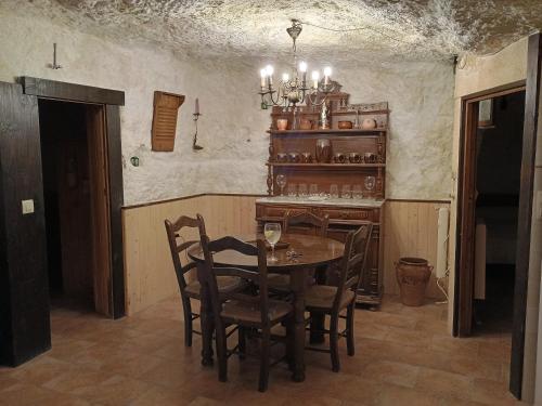 a dining room with a table and chairs at Cueva a 10 min de Albacete in Chinchilla de Monte Aragón