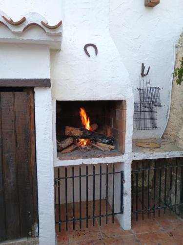 a brick oven with a fire in it at Cueva a 10 min de Albacete in Chinchilla de Monte Aragón