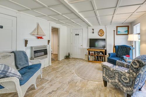 a living room with two chairs and a tv at Explore Coastal Maine! Cozy Apt with Yard and Garden in Orland