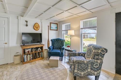 a living room with two chairs and a television at Explore Coastal Maine! Cozy Apt with Yard and Garden in Orland