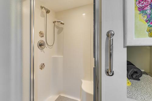 a bathroom with a shower with a glass door at Explore Coastal Maine! Cozy Apt with Yard and Garden in Orland