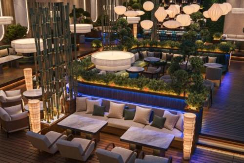 a hotel lobby with tables and couches and plants at Crowne Plaza Dushanbe by IHG in Dushanbe