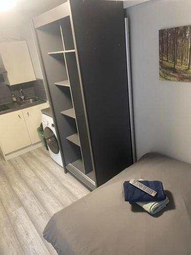 a bedroom with a bed and a black closet at Woolwich Ensuite Roomz in Woolwich