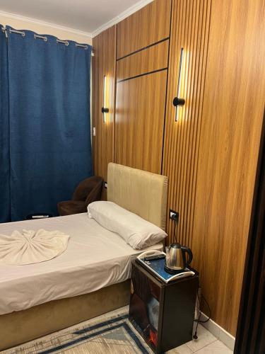 a bedroom with a bed and a chair and a table at Miracle Pyramids View Hotel in Giza
