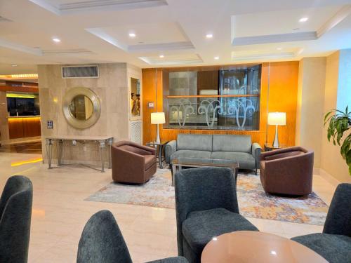 a lobby with couches and a table and chairs at San Carlos Hotel New York in New York
