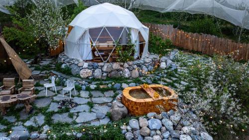 a garden with a igloo and a tent at Glamoreo - The Walnut Glamp in Cheog