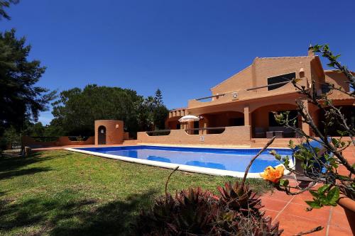 a house with a swimming pool in front of it at Casa Monte Novo in Lagoa