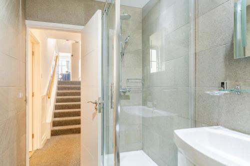 a bathroom with a shower and a sink at Harbour Sands - St Ives in St Ives