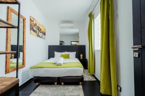 a bedroom with a king sized bed with yellow accents at DOMAINE DU DOUAR in Marrakech