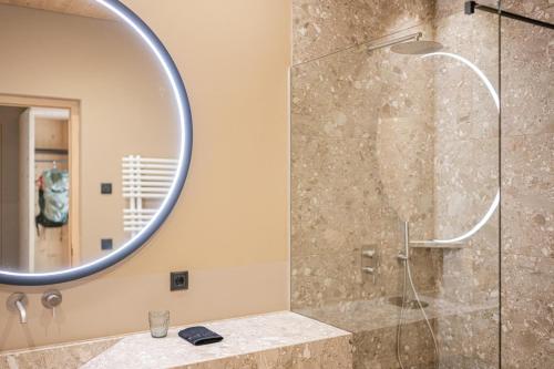a bathroom with a shower with a mirror and a sink at Munt Dolomiti Farm in Plancios