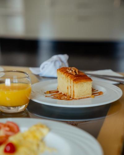 a piece of cake on a plate on a table at DOMAINE DU DOUAR in Marrakech
