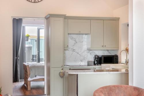 a kitchen with white cabinets and a counter top at Westfield Retreat in Hunmanby