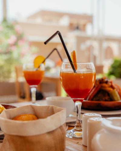 a table with two drinks and a bowl of food at DOMAINE DU DOUAR in Marrakech