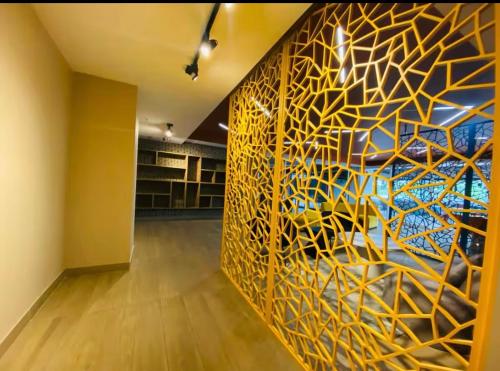 a hallway with a wall with a painting on it at Luxury apartment 10 min to Airport Be Cariari Condo #402 in La Asunción