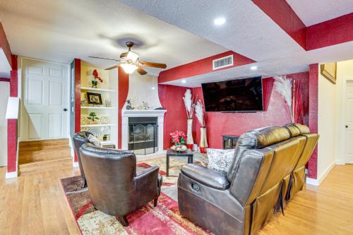 a living room with two leather chairs and a tv at 13 Mi to Downtown El Paso Home with Game Room and Bar in El Paso