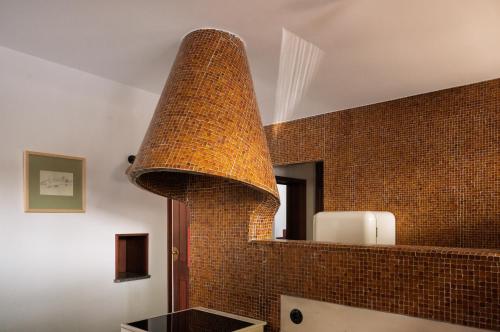 a brick wall in a bathroom with a brick fireplace at Casa d'Abreu Neto - Siza's First Work in Matosinhos