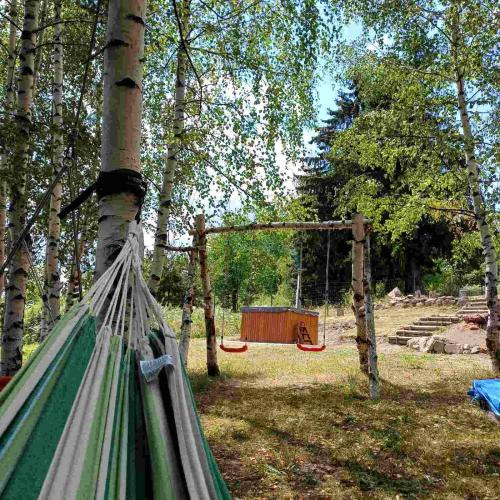 a hammock tied to a tree in a park at Вила Брезите in Pamporovo