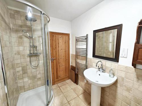 a bathroom with a sink and a glass shower at Low Moor Farm in Cotterdale