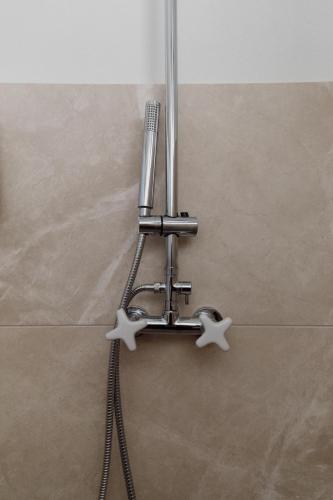 a metal towel rack with two stars on the wall at Casa d'Abreu Neto - Siza's First Work in Matosinhos