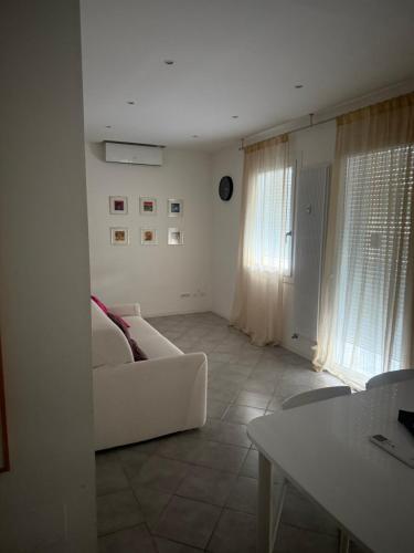 a living room with a white couch and a table at ApartmentsPadova in Padova