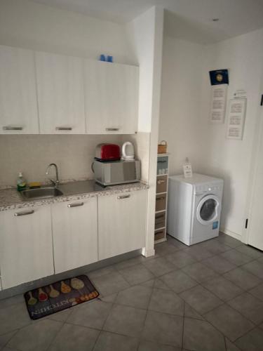 a kitchen with a sink and a washing machine at ApartmentsPadova in Padova