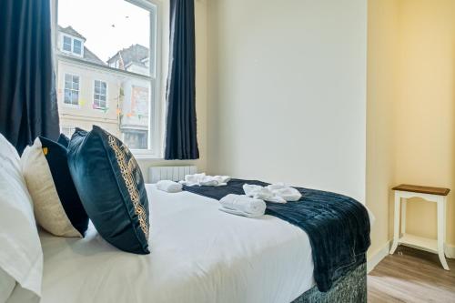 a bed with towels on it with a window at Prime Location - Modern 1BR in Canterbury Centre in Canterbury