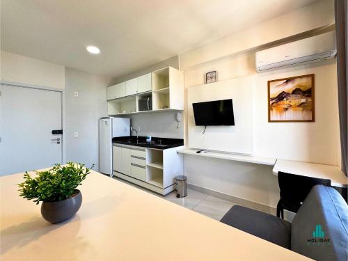 a room with a kitchen with a table and a refrigerator at Compact Time by Holiday Stays in João Pessoa