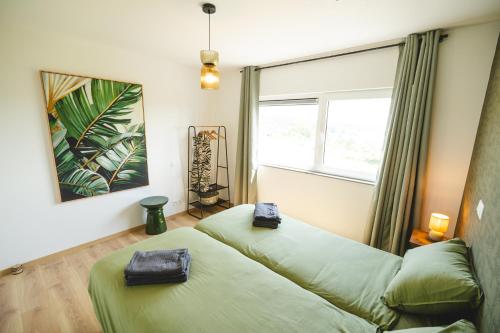 a room with two beds and a window at Savana Moon in Heer