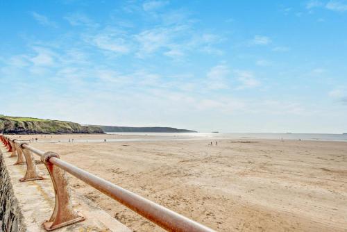 a view of a beach with people in the water at Bwythyn Y Mor - Broad Haven in Broad Haven