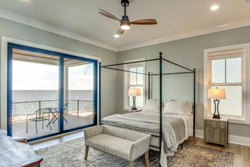 a bedroom with a bed and a view of the ocean at Luxury Beachfront Living! Epic Ocean Springs Home in Ocean Springs