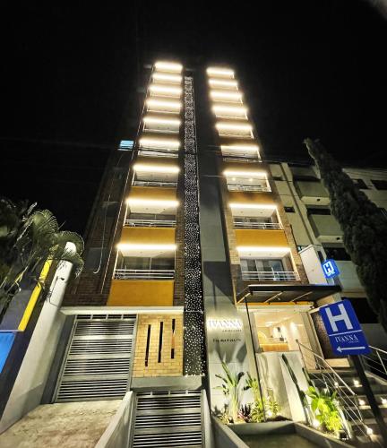 a tall building at night with its lights on at Ivanna Jumar ApartaHotel in Medellín